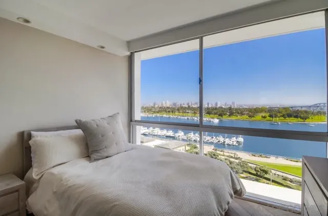 a bed sitting in a bedroom next to a window