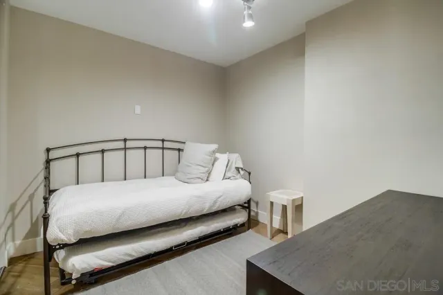 a bedroom with a bed and two night stand