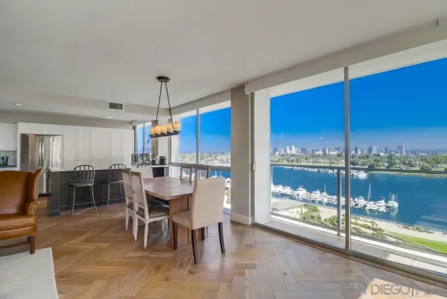 a dining room with furniture window and chandelier
