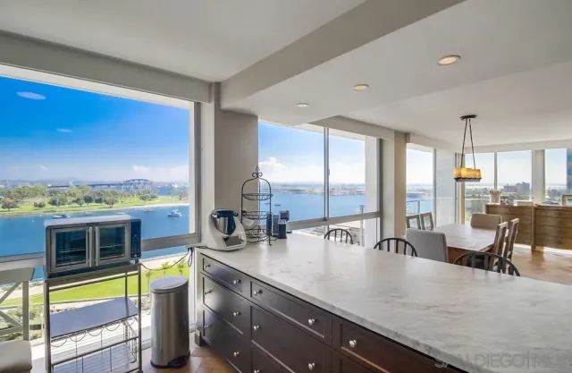 a kitchen with stainless steel appliances granite countertop a sink a stove and a wooden cabinets