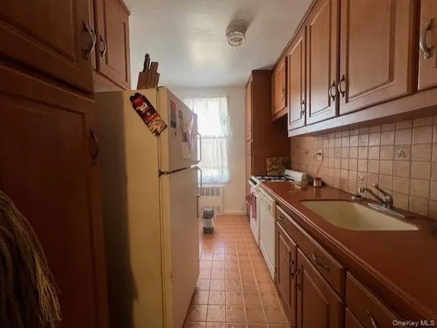 a kitchen with a sink stove and refrigerator