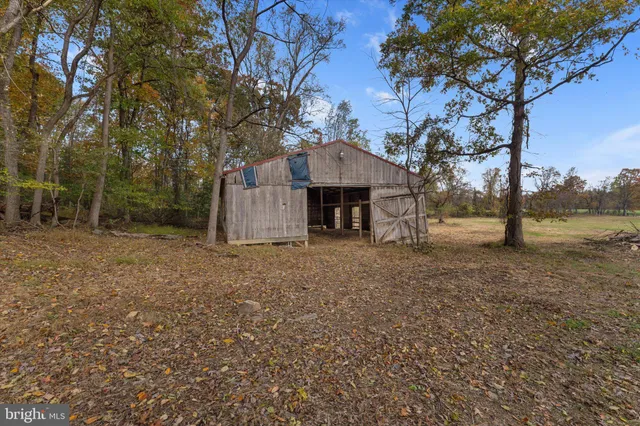 a view of a house with a yard and tree