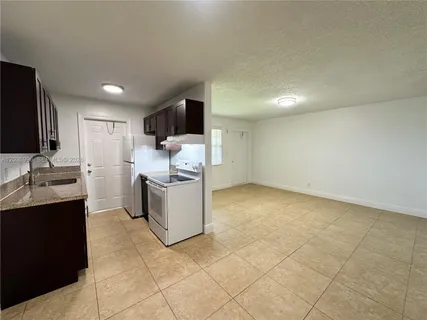 a kitchen with a sink cabinets and stainless steel appliances
