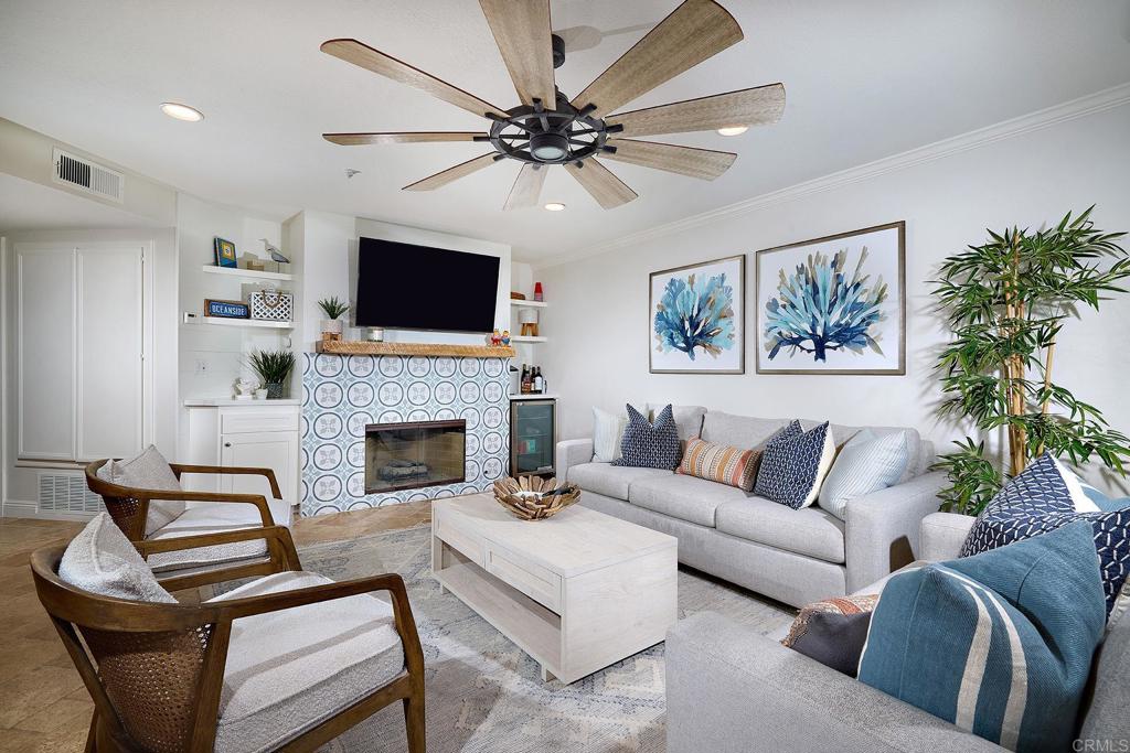 a living room with furniture a flat screen tv and a fireplace