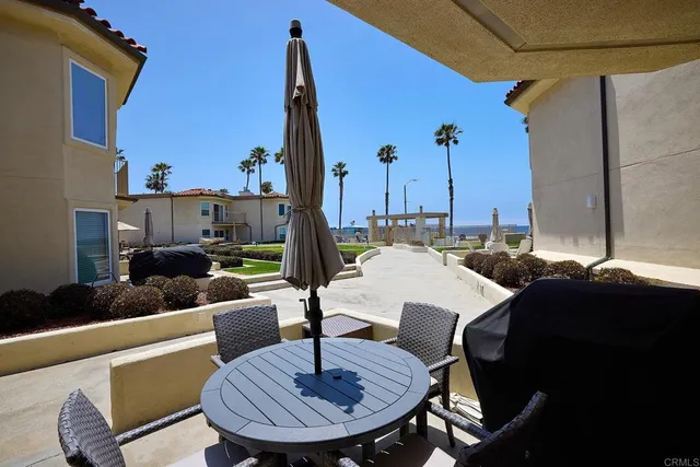 a view of a patio with a table chairs and a potted plant