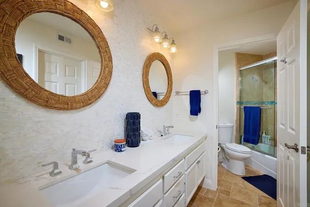 a bathroom with a toilet a sink and a mirror