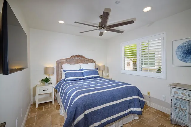 a bedroom with a bed and a tv