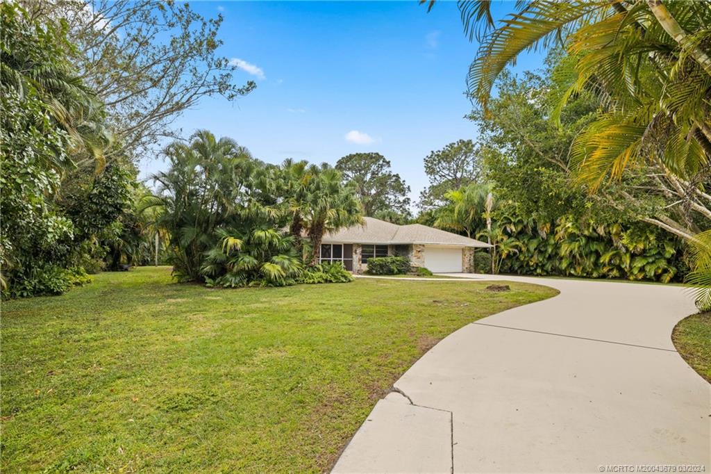 1098 Northwest Fork Road Stuart, FL 34994 - Photo 49 of 54 a view of an house with backyard and garden