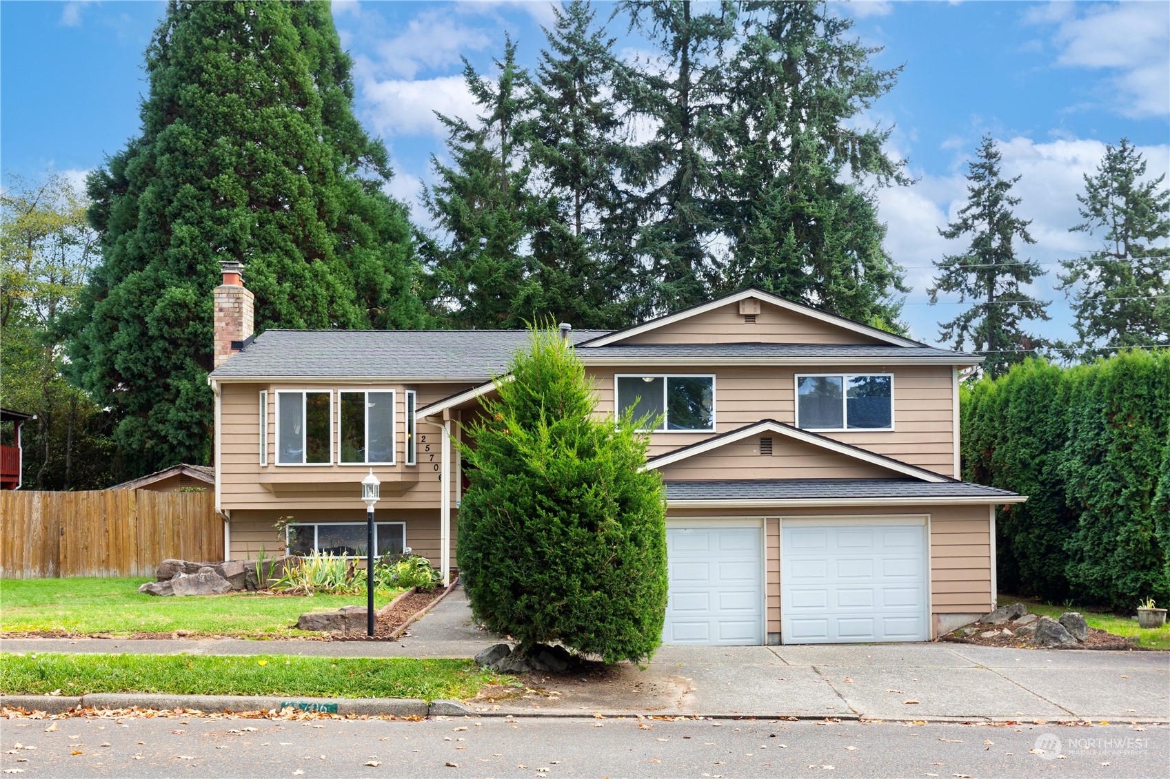 25706 35th Place South Kent, WA 98032 - Photo 1 of 35 a front view of a house with a yard and garage