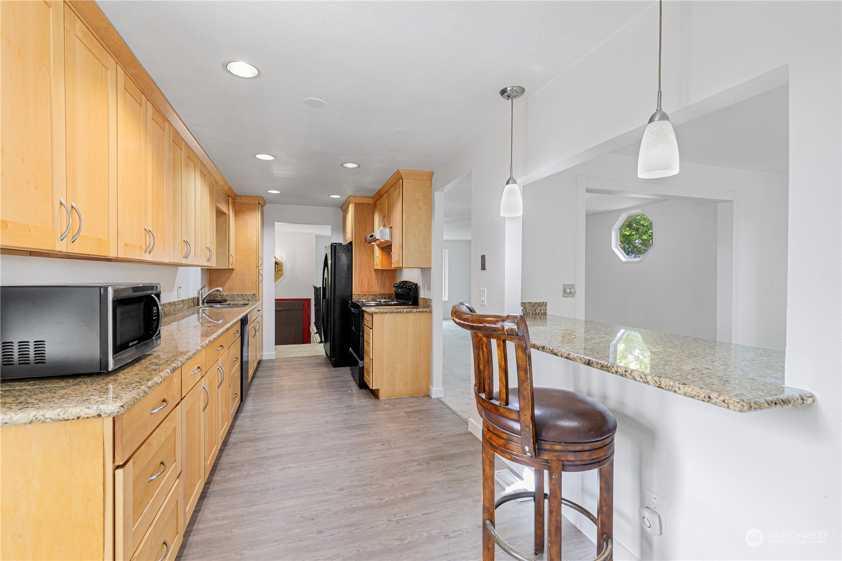 25706 35th Place South Kent, WA 98032 - Photo 13 of 35 a kitchen with stainless steel appliances granite countertop a refrigerator a stove top oven a sink dishwasher and dining table with wooden floor