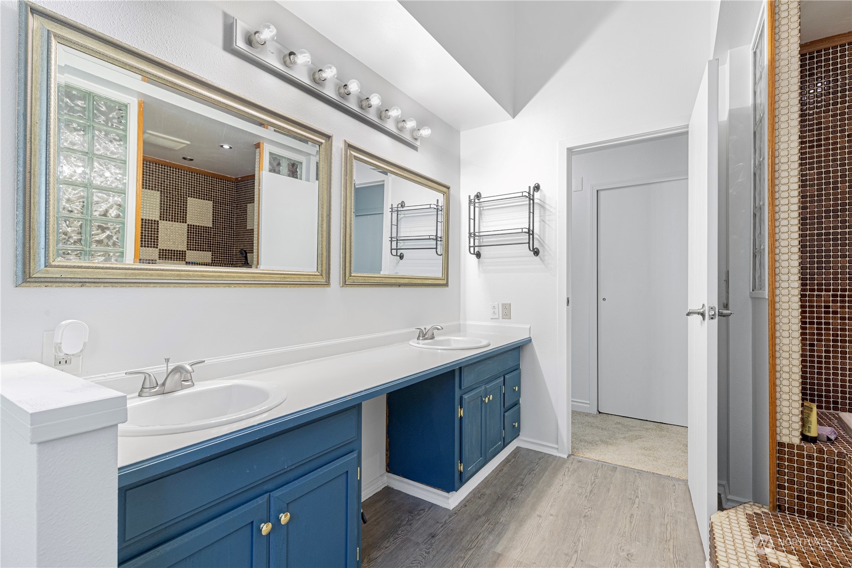 25706 35th Place South Kent, WA 98032 - Photo 16 of 35 a spacious bathroom with a double vanity sink a mirror and a shower