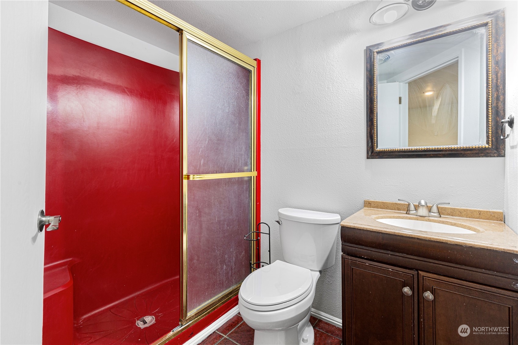 25706 35th Place South Kent, WA 98032 - Photo 24 of 35 a bathroom with a toilet a sink and mirror