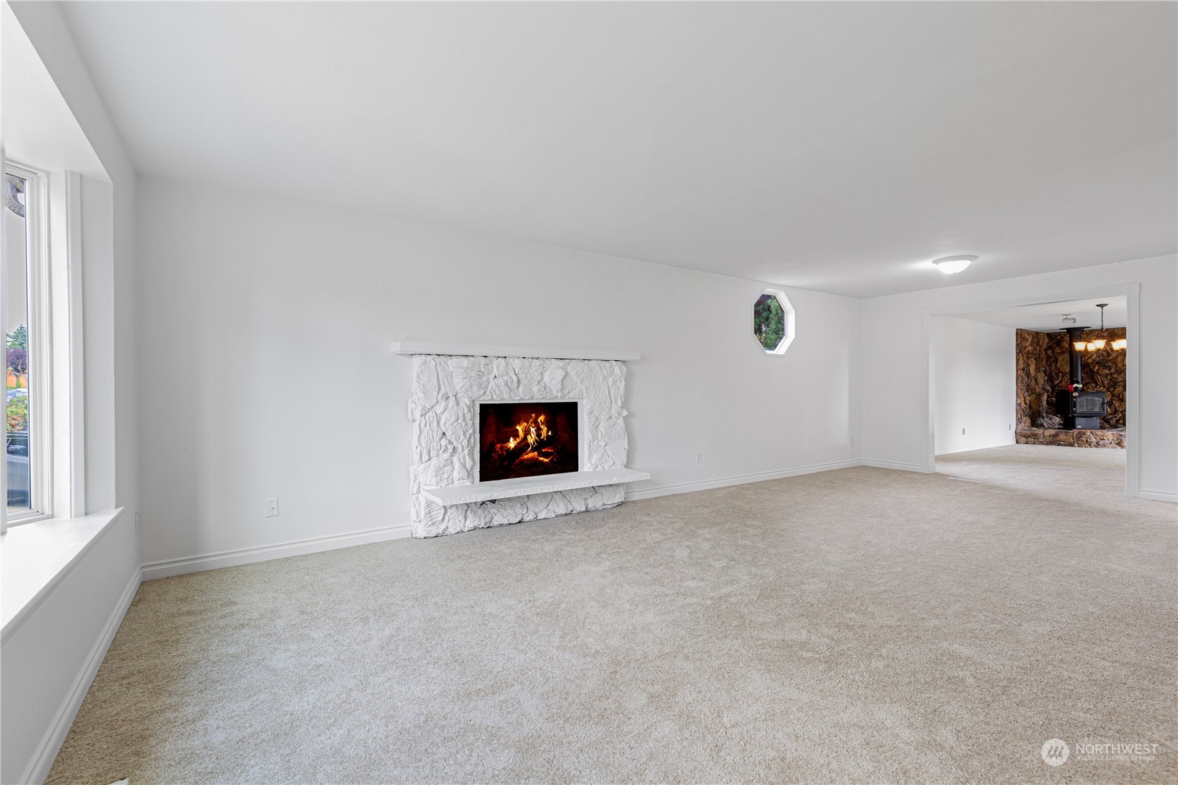25706 35th Place South Kent, WA 98032 - Photo 5 of 35 an empty room with a fireplace and windows