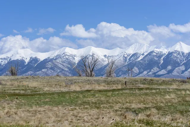 a view of a large pool with a yard in front of it