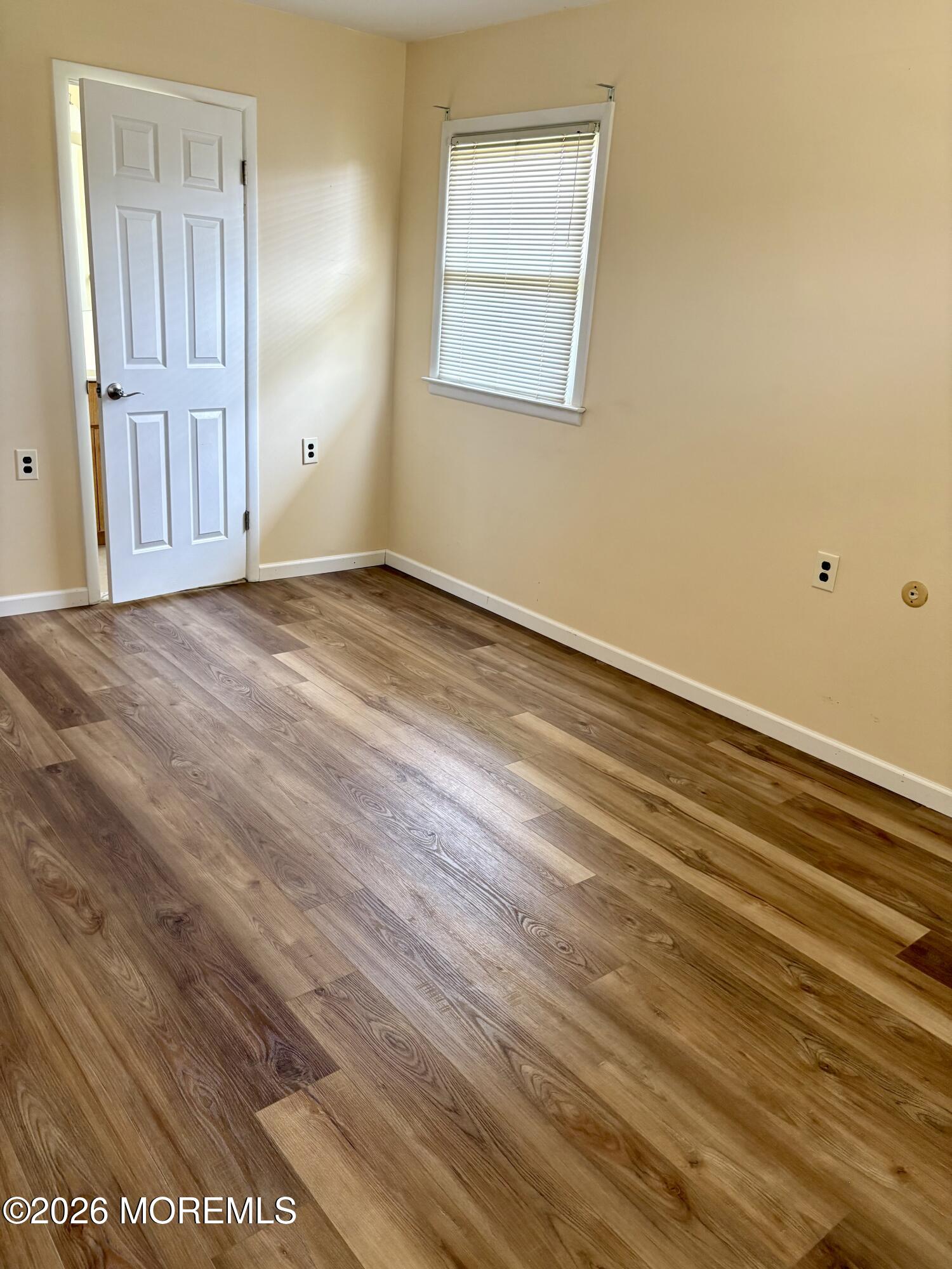 8 Dryden Road Brick, NJ 08724 - Photo 11 of 35 a view of an empty room with wooden floor and a window