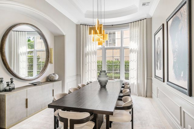 a view of a dining room with furniture large windows and wooden floor