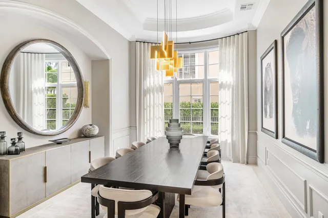 a view of a dining room with furniture large windows and wooden floor