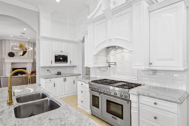 a bathroom with a granite countertop sink a mirror a vanity and a shower