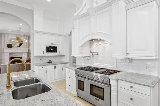a bathroom with a granite countertop sink a mirror a vanity and a shower