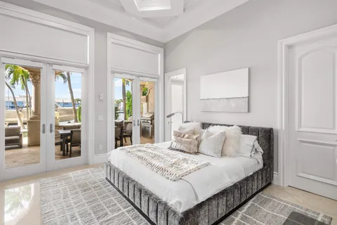 a view of a patio with table and chairs potted plants and palm tree