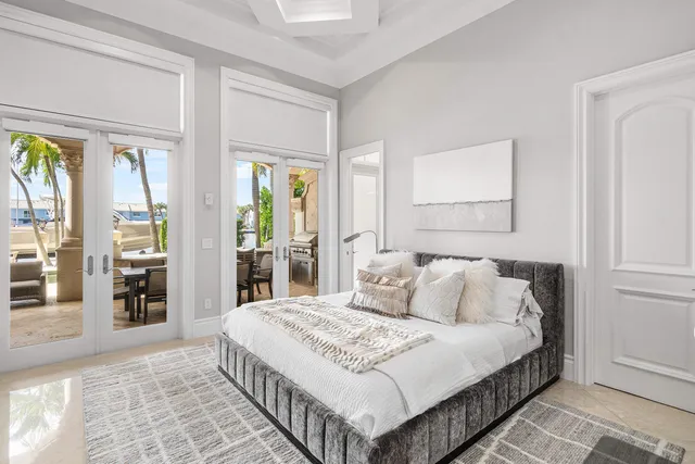a view of a patio with table and chairs potted plants and palm tree