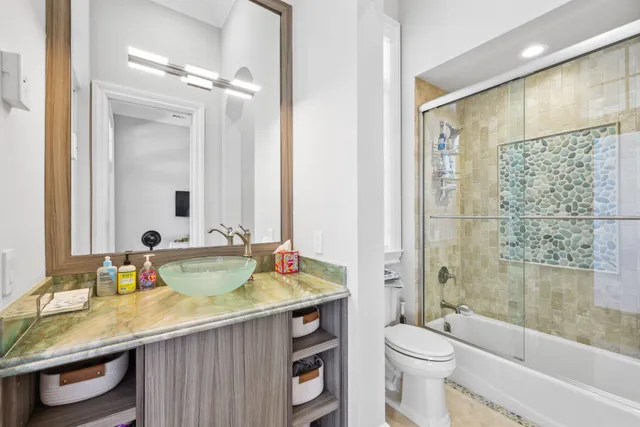 a kitchen with a stove a sink and a chandelier