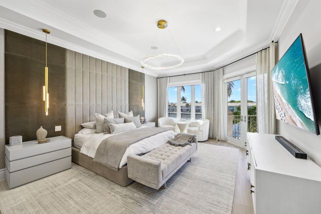 a front view of a house with a garden and a tree