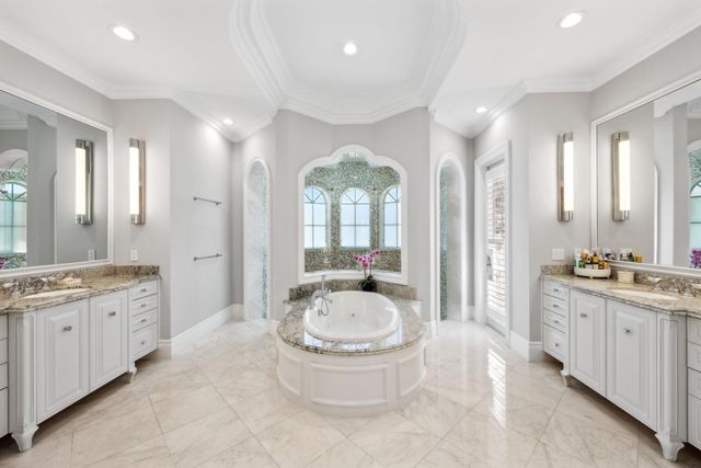 a view of a dining room with furniture and a chandelier