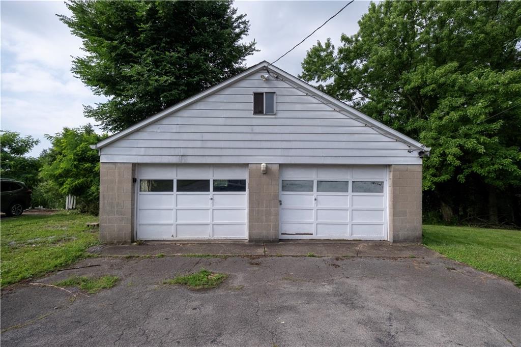 44 Forest Grove Road Coraopolis, PA 15108 - Photo 25 of 29 a front view of a house with a yard and garage