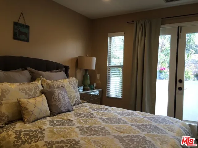 a bedroom with a bed and a lamp