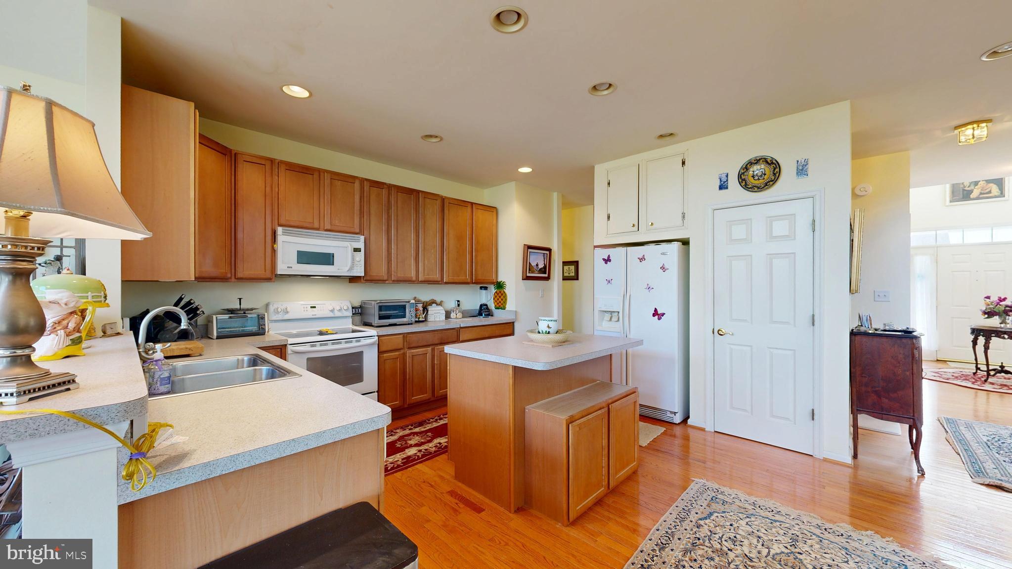 110 Masters Lane Magnolia, DE 19962 - Photo 32 of 65 a kitchen with a refrigerator a stove top oven a sink and cabinets
