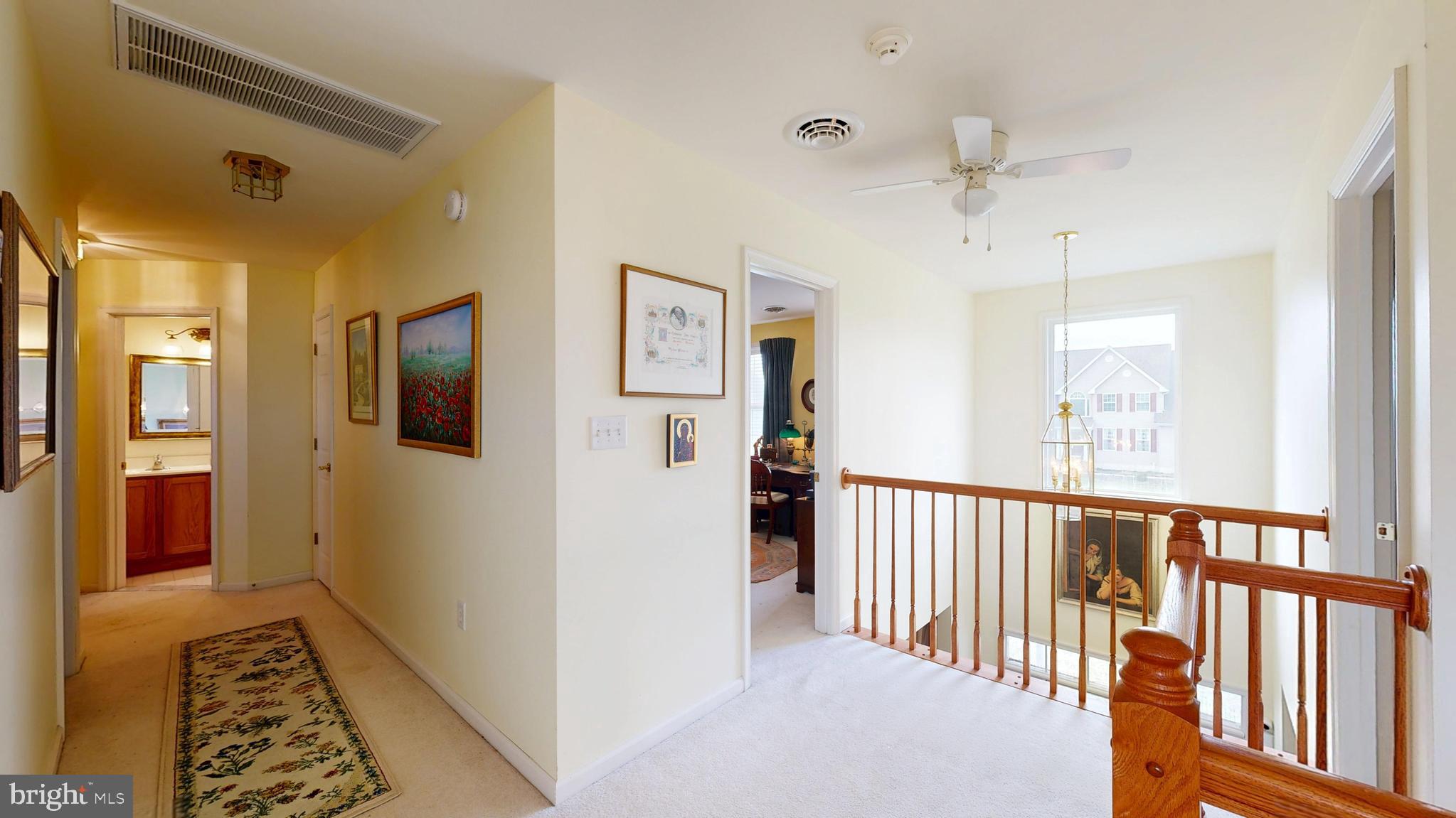 110 Masters Lane Magnolia, DE 19962 - Photo 39 of 65 a view of hallway with wooden floor and a chandelier
