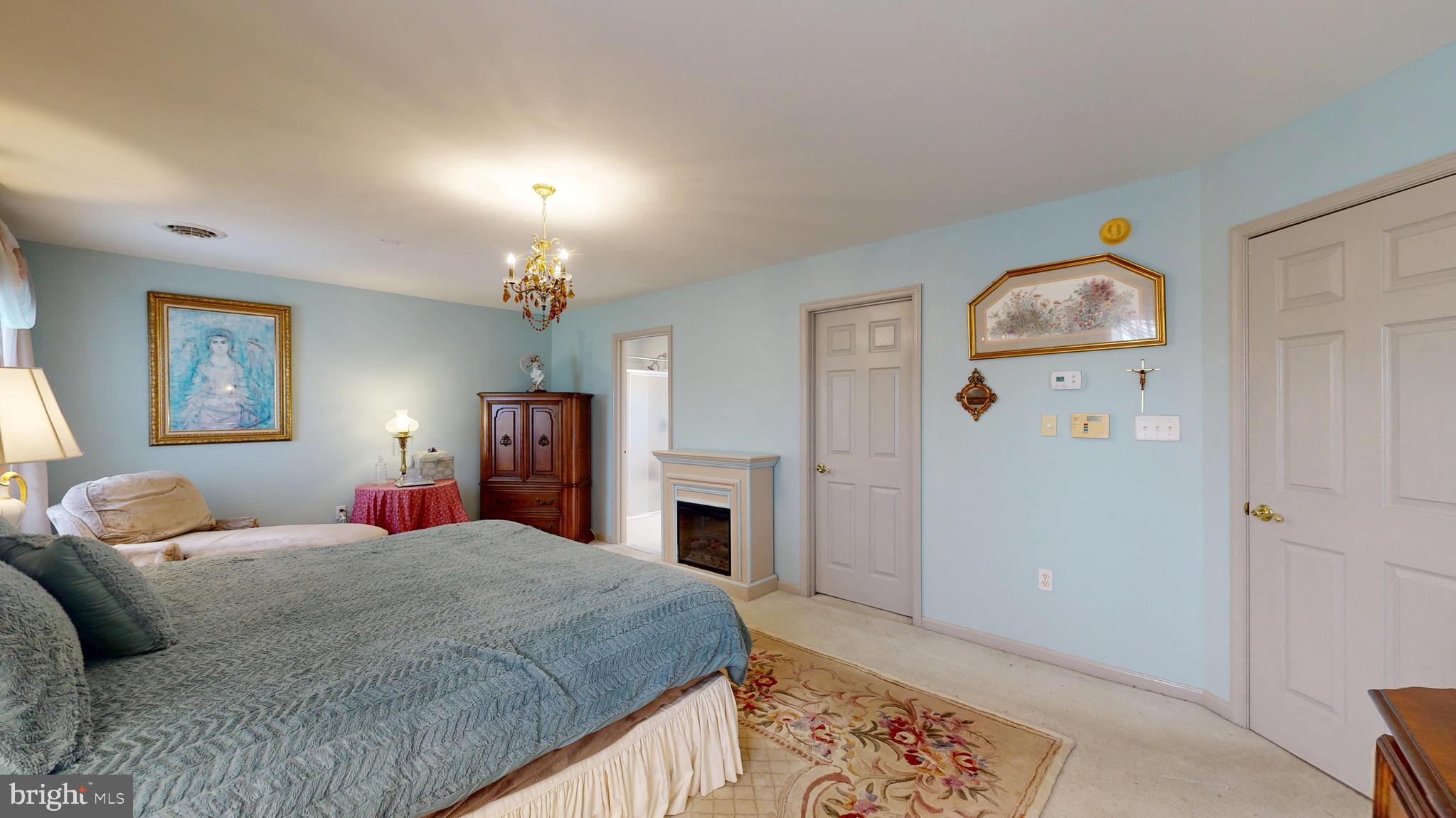 110 Masters Lane Magnolia, DE 19962 - Photo 55 of 65 a bedroom with a bed and a chandelier