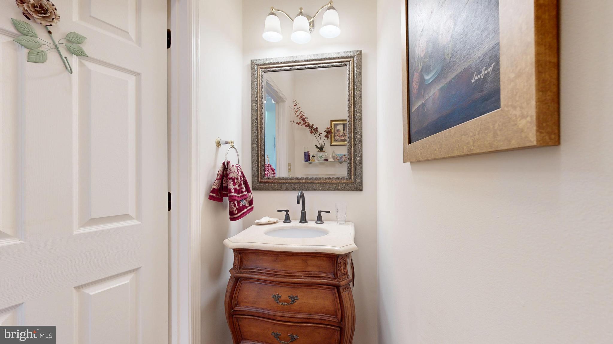 110 Masters Lane Magnolia, DE 19962 - Photo 56 of 65 a bathroom with a sink and a mirror