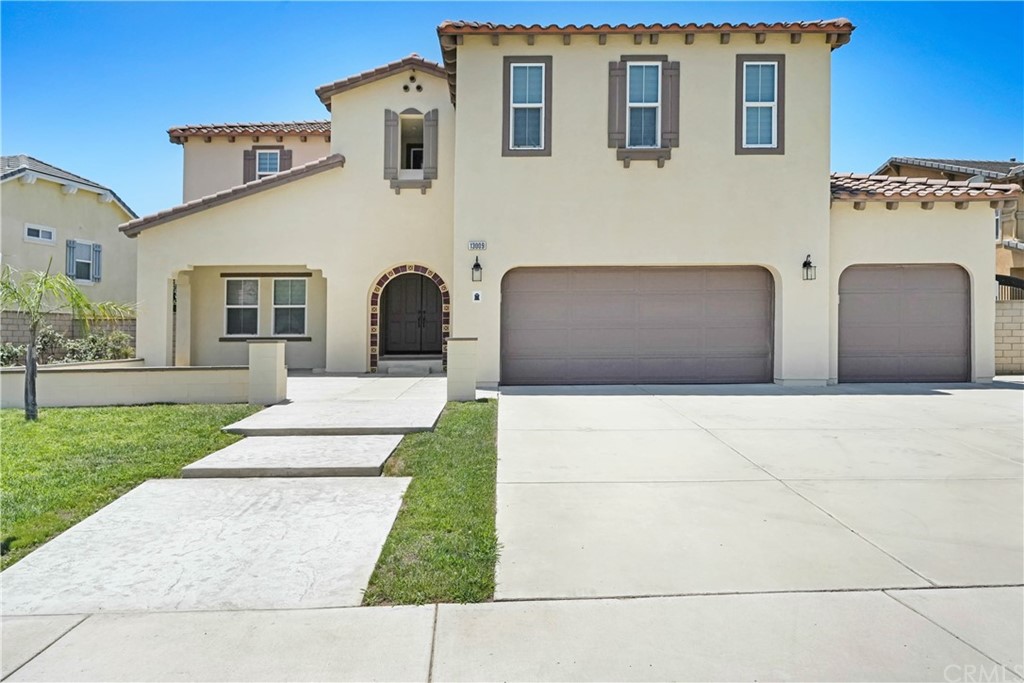 13009 Quail Court Rancho Cucamonga, CA 91739 - Photo 1 of 1 a front view of a house with a yard and garage