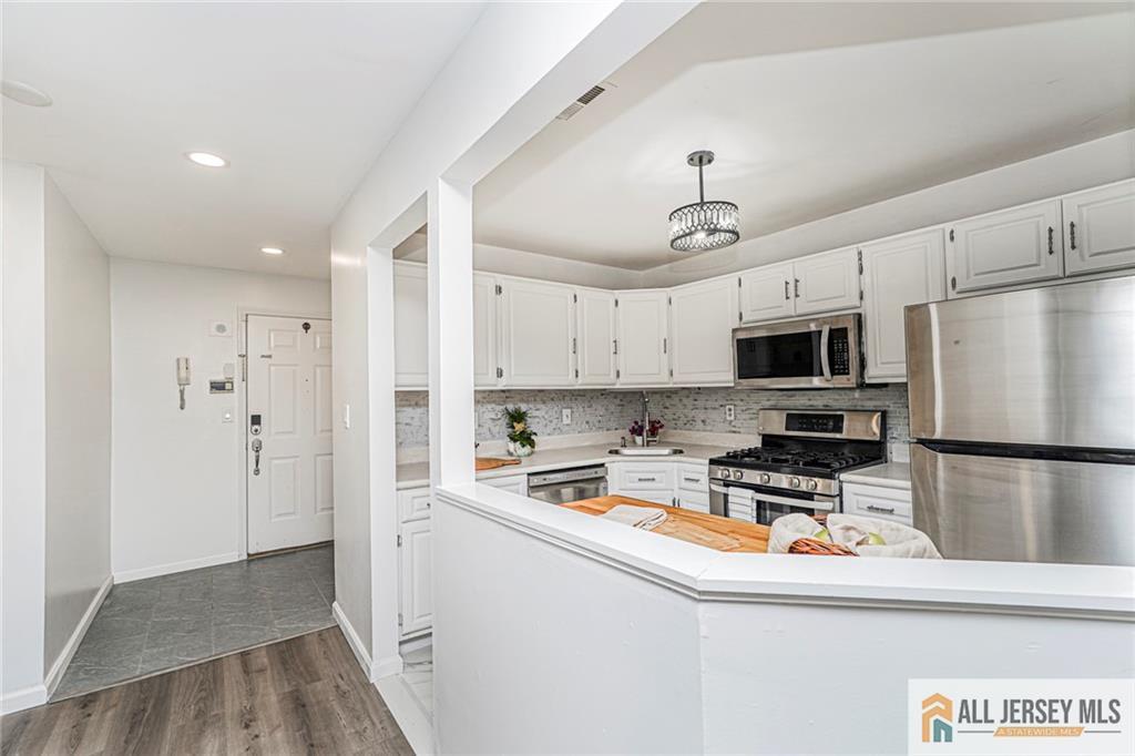 612 Chester Court Helmetta, NJ 08828 - Photo 24 of 31 a kitchen with stainless steel appliances a refrigerator stove microwave and cabinets