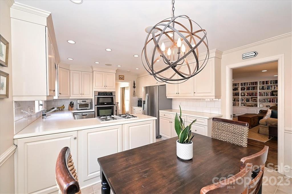 3724 Merrifield Road Charlotte, NC 28211 - Photo 14 of 48 a kitchen with stainless steel appliances granite countertop a sink a kitchen island a stove a dining table and chairs