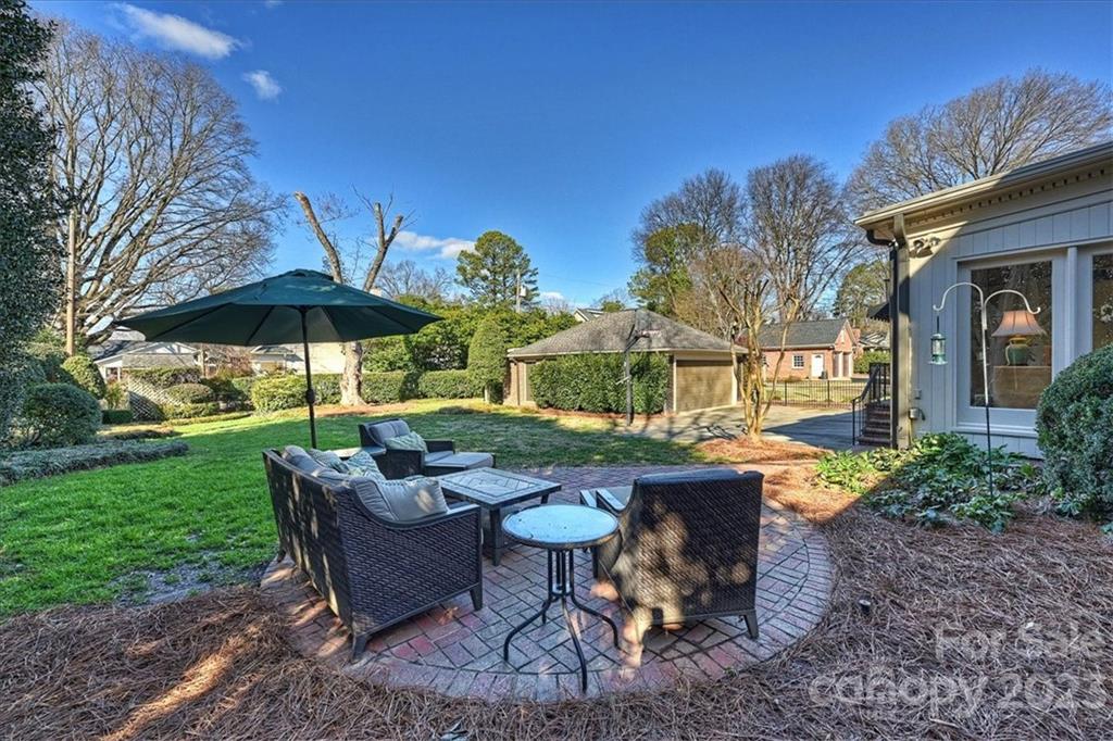 3724 Merrifield Road Charlotte, NC 28211 - Photo 43 of 48 a view of a patio with chairs and table under an umbrella