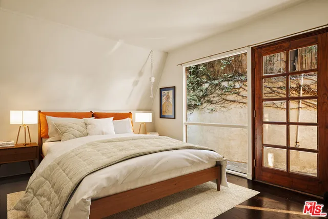 a bedroom with a large bed and a large window