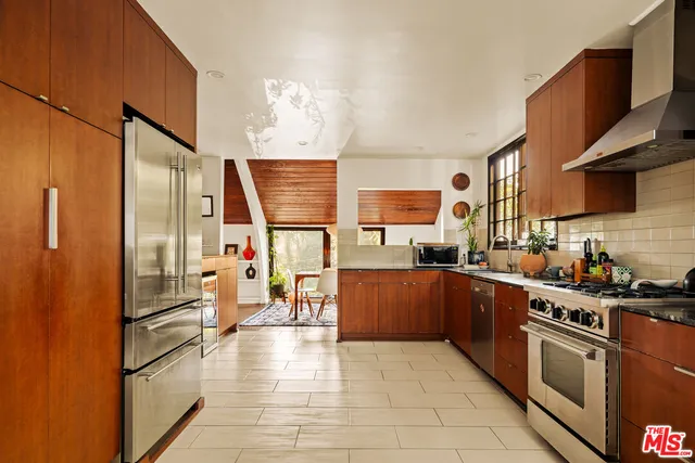 a kitchen with stainless steel appliances granite countertop a sink and cabinets