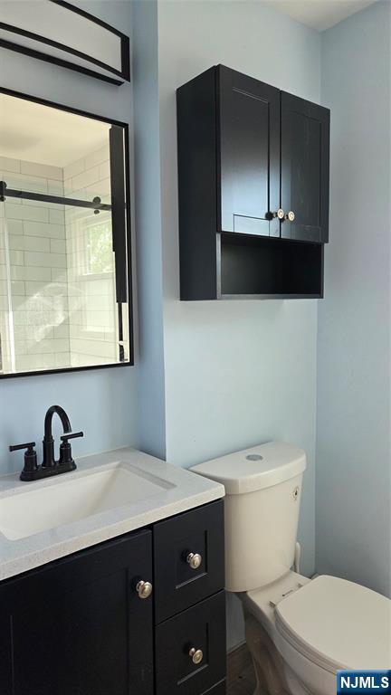 159-161 Tappan Street, Unit TOP Kearny, NJ 07032 - Photo 5 of 12 a bathroom with a toilet a sink and mirror