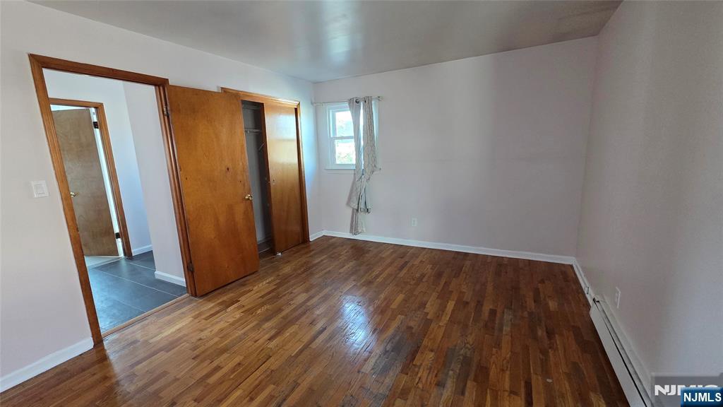 159-161 Tappan Street, Unit TOP Kearny, NJ 07032 - Photo 8 of 12 an empty room with wooden floor and entrance