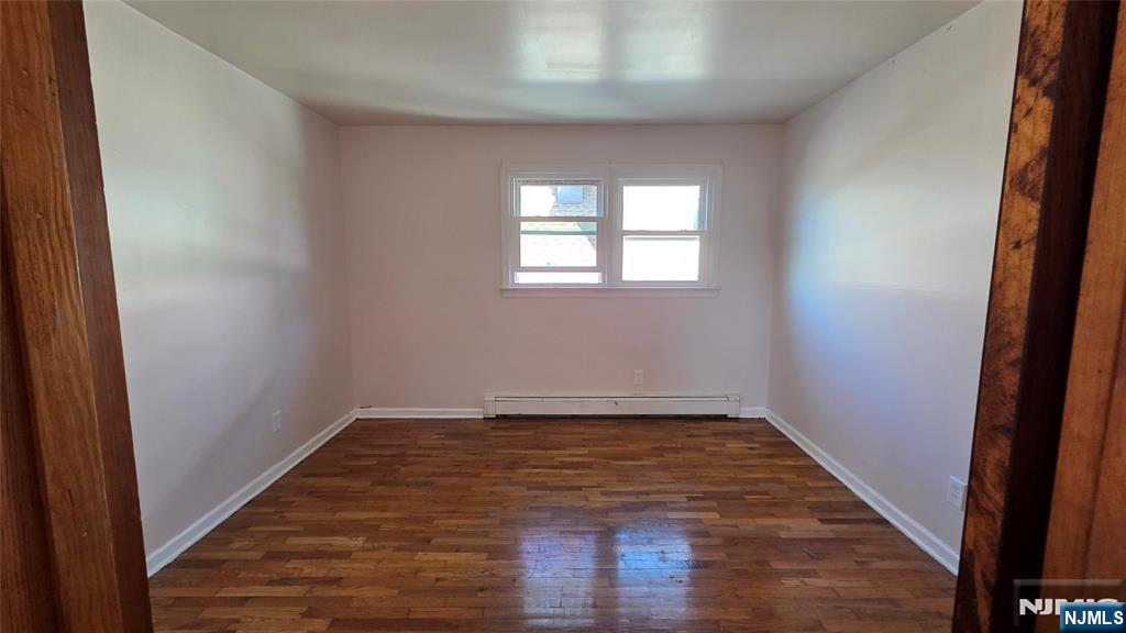 159-161 Tappan Street, Unit TOP Kearny, NJ 07032 - Photo 9 of 12 wooden floor in an empty room with a window