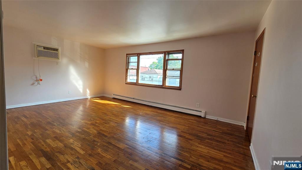 159-161 Tappan Street, Unit TOP Kearny, NJ 07032 - Photo 10 of 12 a view of an empty room with wooden floor and a window