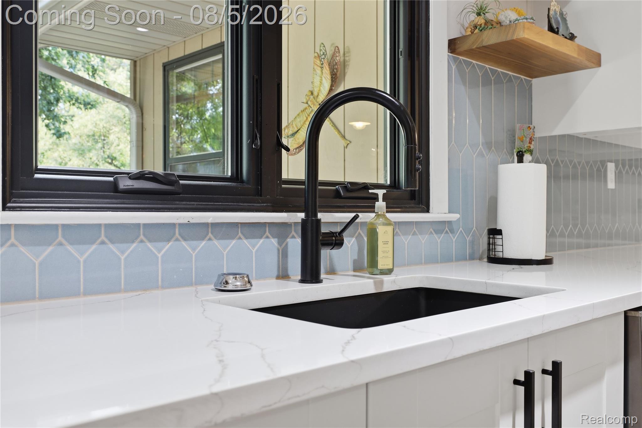 6478 West Stanley Road Mount Morris, MI 48458 - Photo 37 of 80 Kitchen sink with a matte black faucet, set against a white countertop and light blue picket tile backsplash