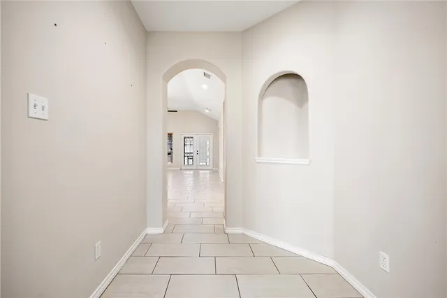 an empty room with windows and a fireplace