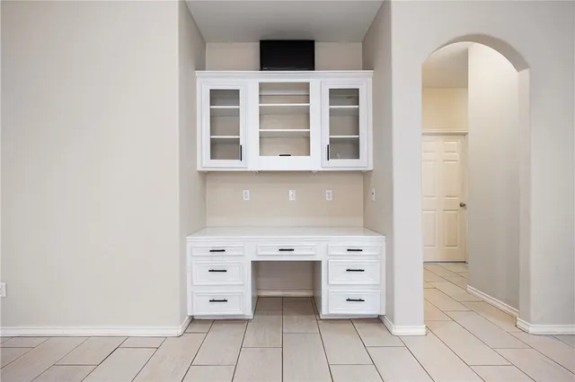 a view of kitchen with cabinets and window