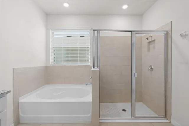 a bathroom with a bathtub and a shower