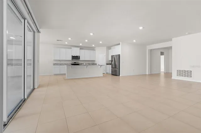 a view of a kitchen with a sink and a refrigerator