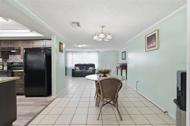 a kitchen with granite countertop stainless steel appliances and wooden floor